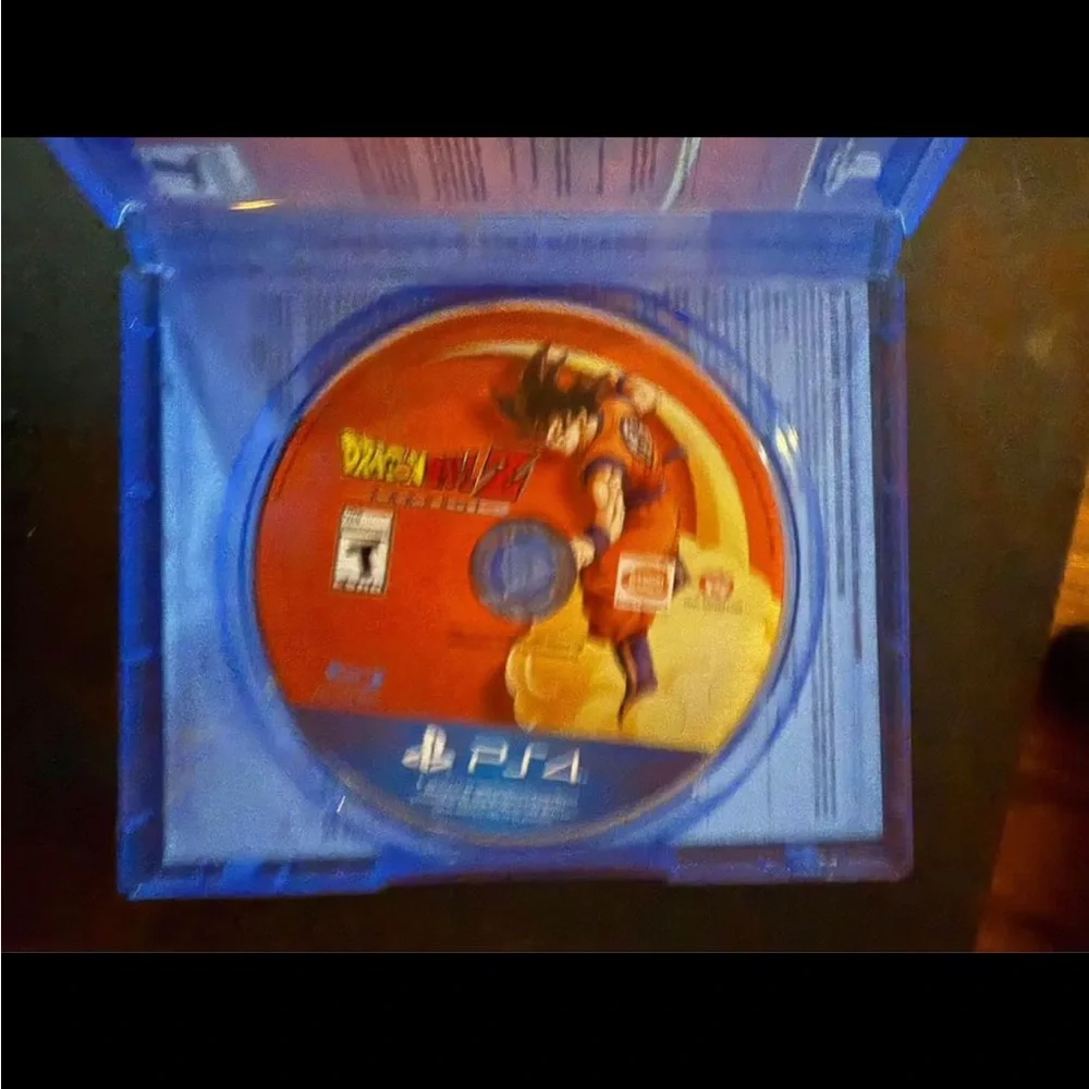 PlayStation 4 with two controllers and Dragonball Z Kakorat